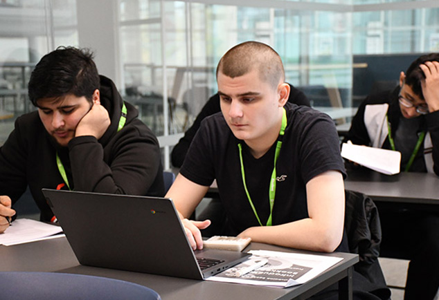Students sitting at a table working independently 