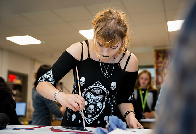 Students working inside a well equipped art studio