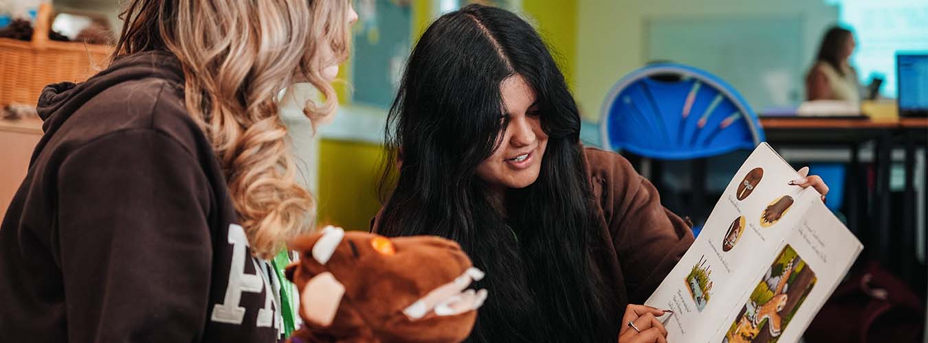 Students reading childrens book