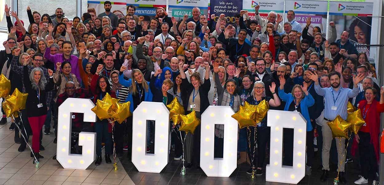 Buckinghamshire College Group staff cheering behind large letters that read 'Good'