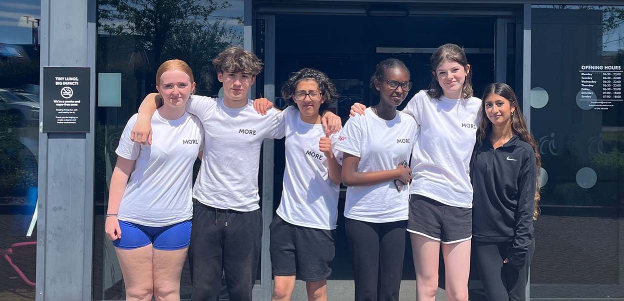 Students standing together in front of Leisure Centre